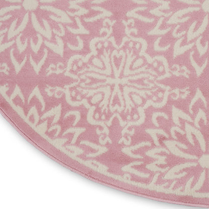 Round pink rug with white mandala floral pattern for farmhouse floor decor.