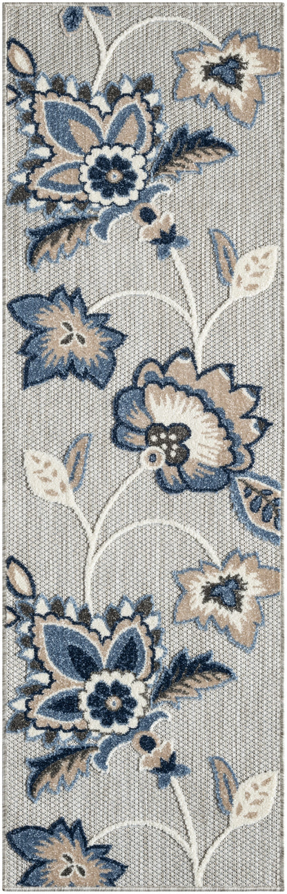 Long rectangular rug with blue, beige & cream floral motif on light gray woven background; large blooms & vines.