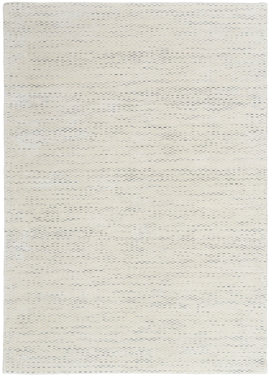 Cream beige flat-weave rug with subtle speckled texture for neutral, modern decor.