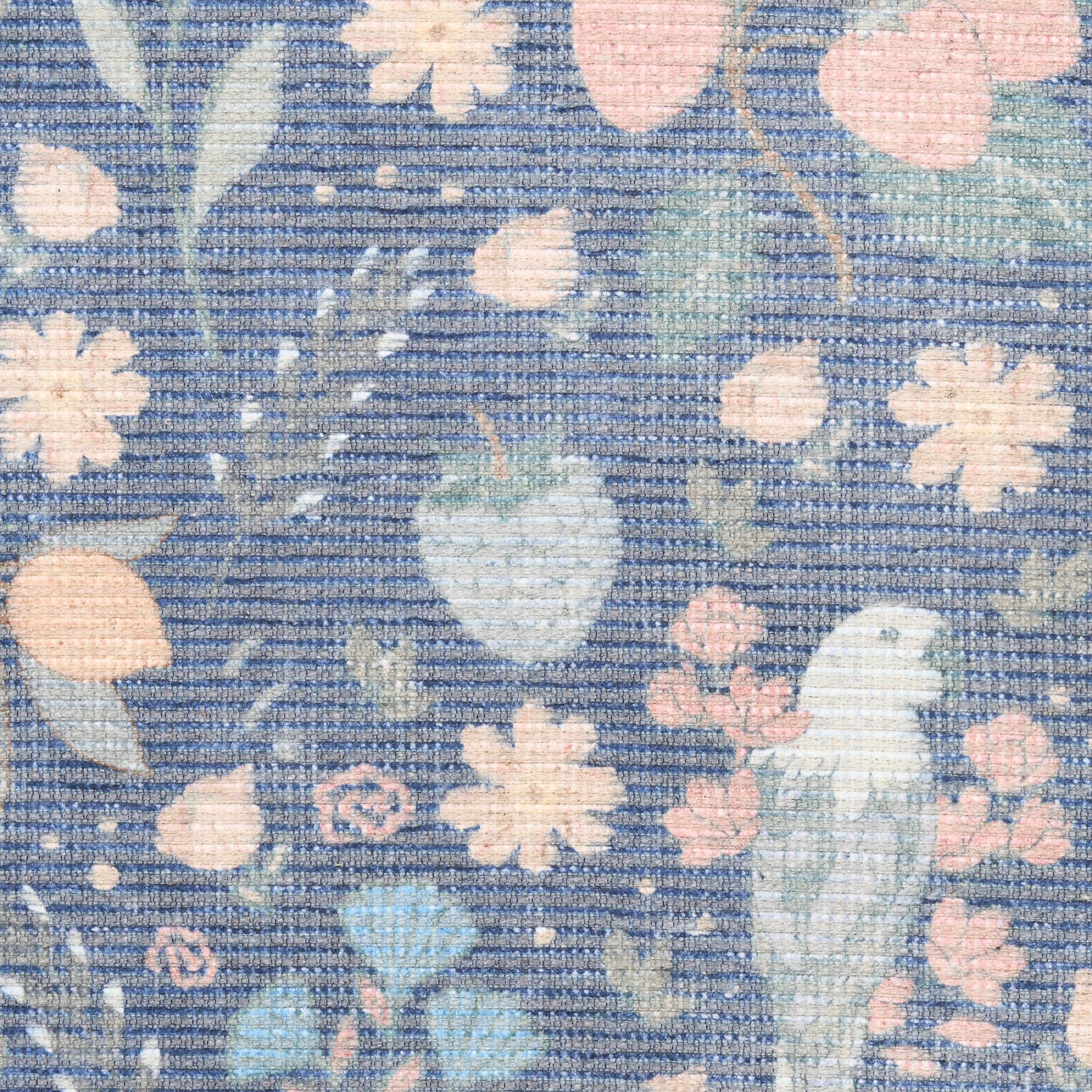 Pastel floral print fabric with peach and pink flowers, mint leaves and a light blue bird on a blue striped background.