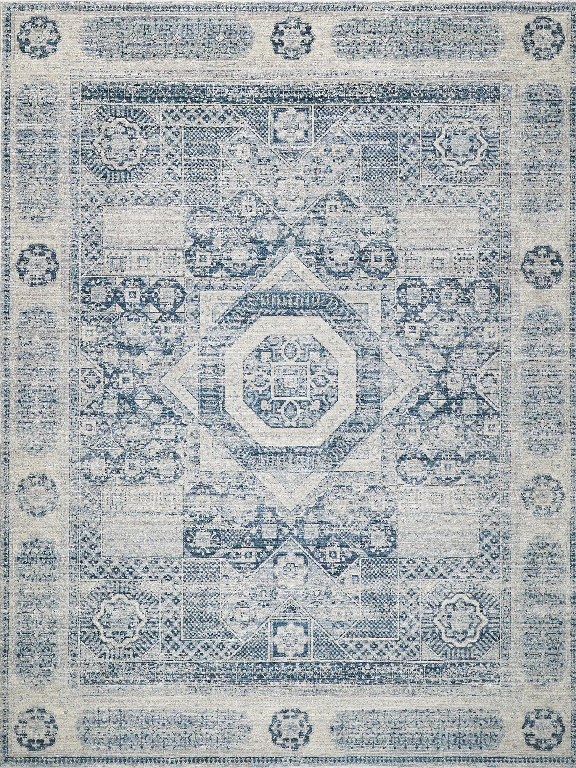 Distressed blue and ivory oriental rug with intricate geometric medallion center and ornate border.