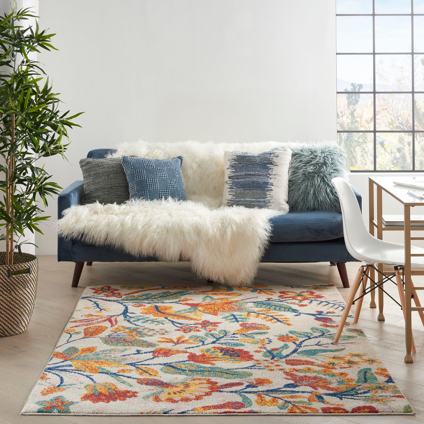 Colorful floral Bohemian rug, 4' x 6', on the floor by a large window.
