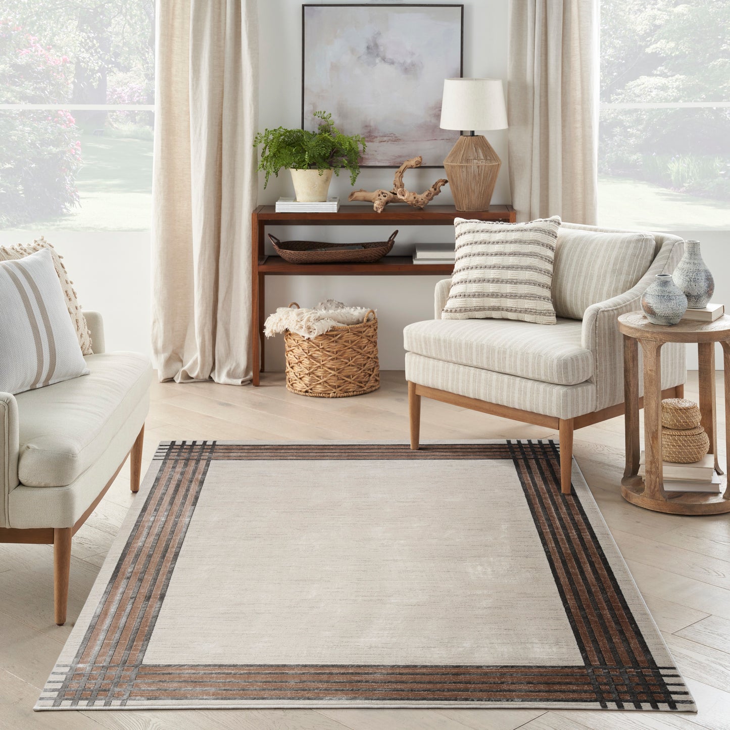 Neutral mid-century living room with light beige seating, wooden legs, cream rug with brown striped border, wicker basket, plants.