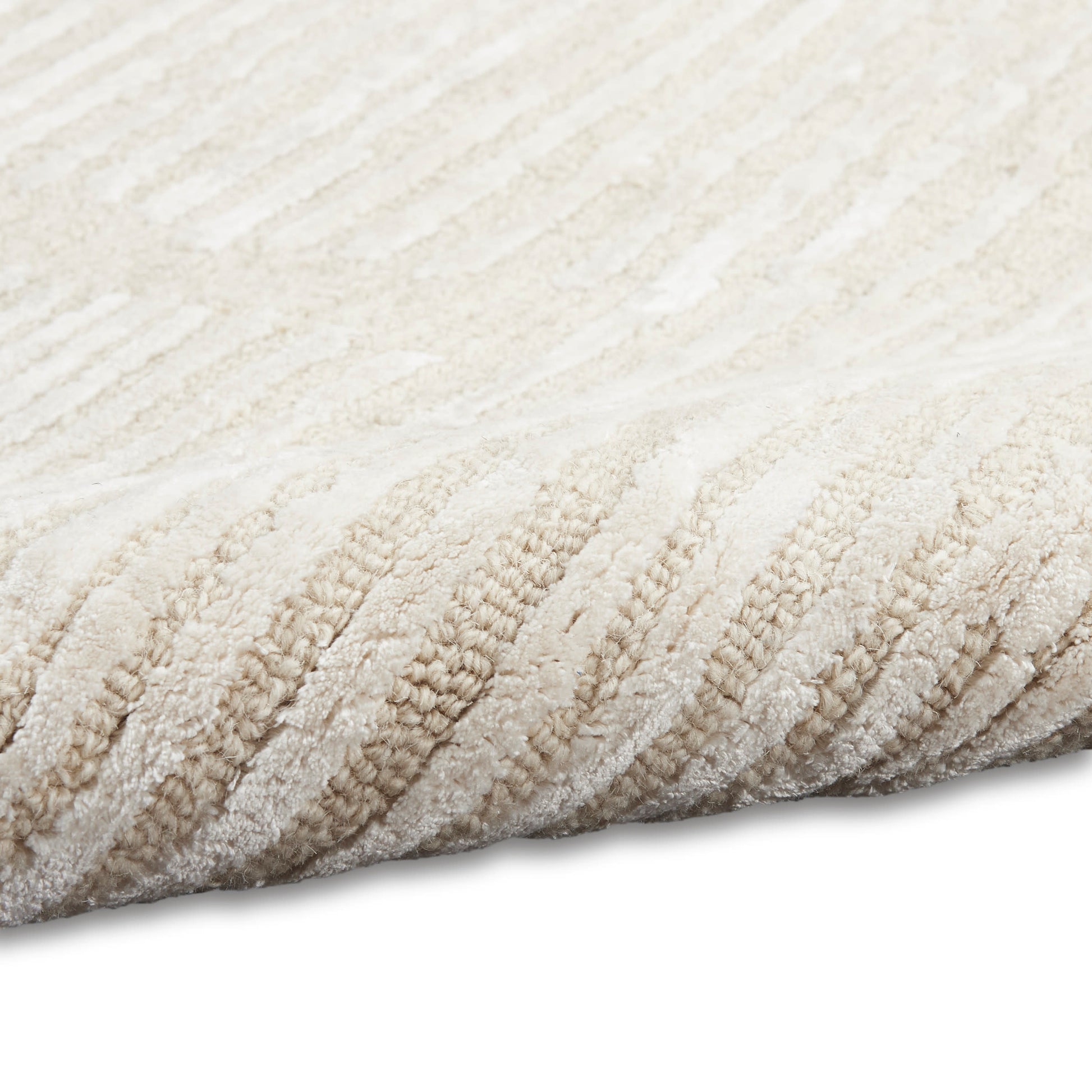 Beige striped rug with soft plush pile and textured weave for neutral home decor.