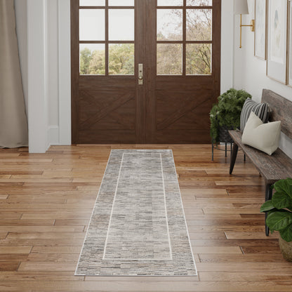Light-gray 8' runner rug on oak floor in an entryway.