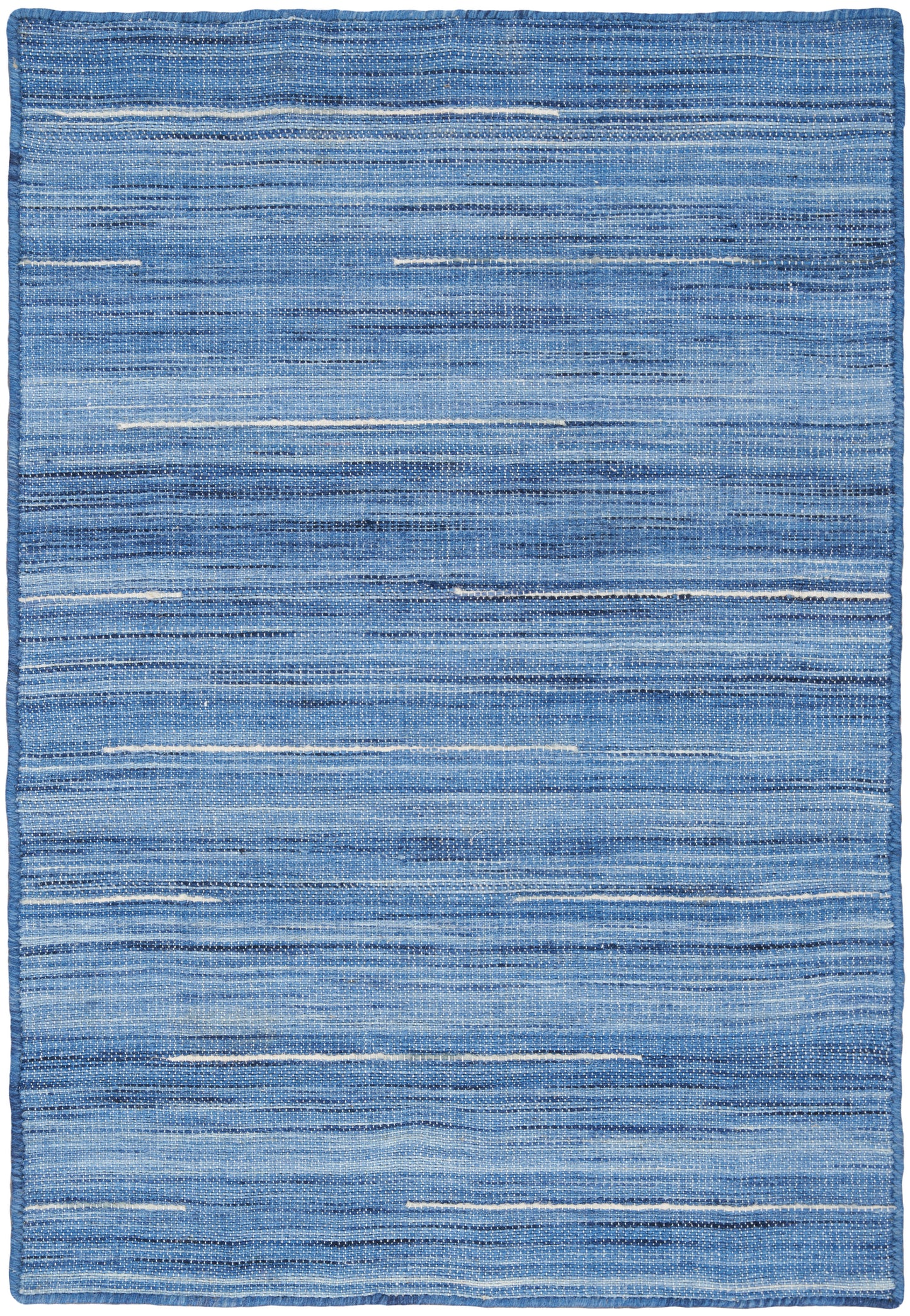 Blue striped woven rug with varied light and dark denim tones and textured horizontal bands.