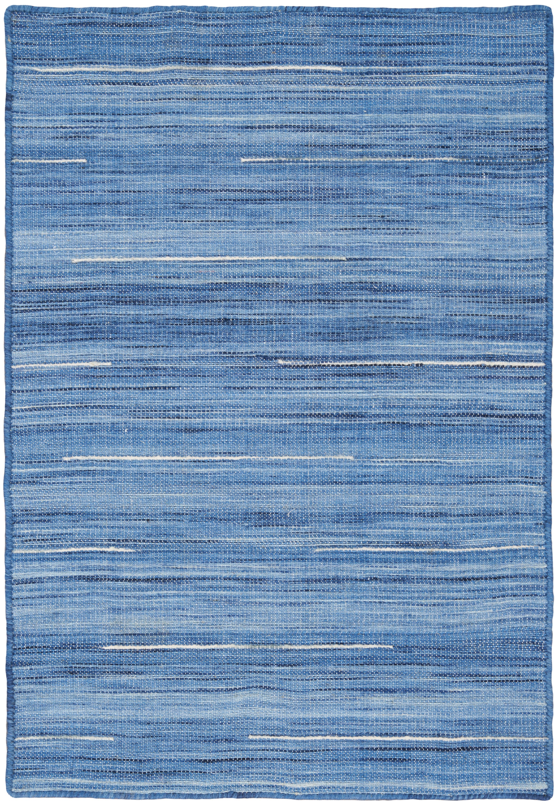 Blue striped woven rug with varied light and dark denim tones and textured horizontal bands.