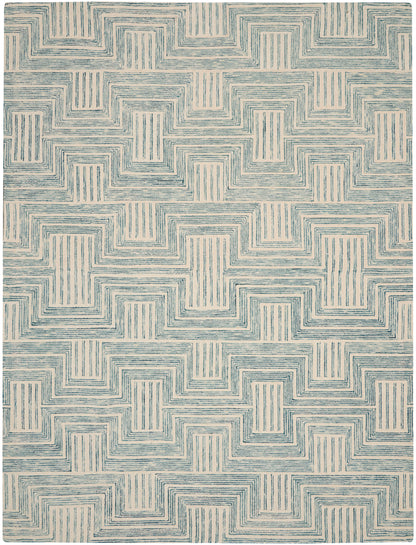 Beige area rug with blue interlocking stepped-square lines forming a repeating labyrinth motif.