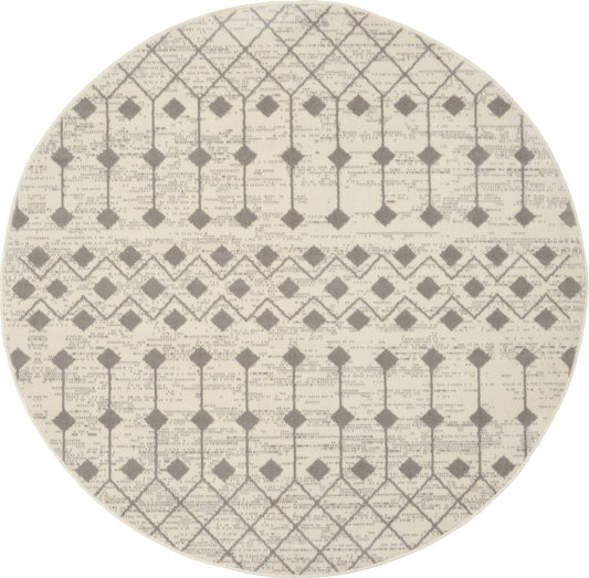 Round beige rug with gray geometric lattice and diamond patterns; woven texture.