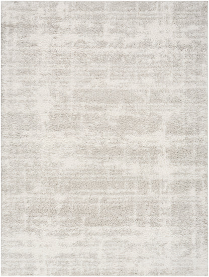 Rectangular cream and taupe rug with a soft plush pile and subtle distressed pattern.