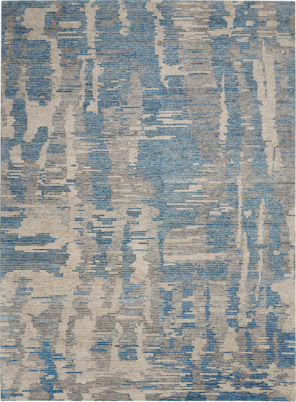 Blue & beige abstract rug with a distressed pattern; modern, contemporary area rug.