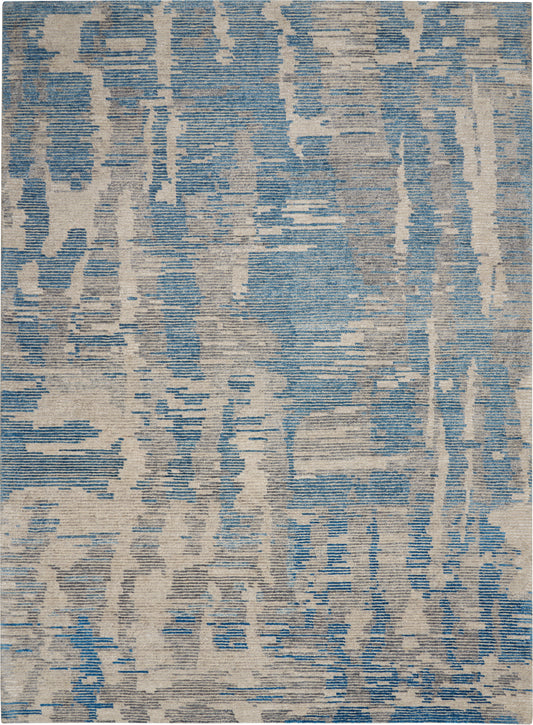 Rectangular area rug with a blue and beige abstract distressed pattern; modern contemporary style.