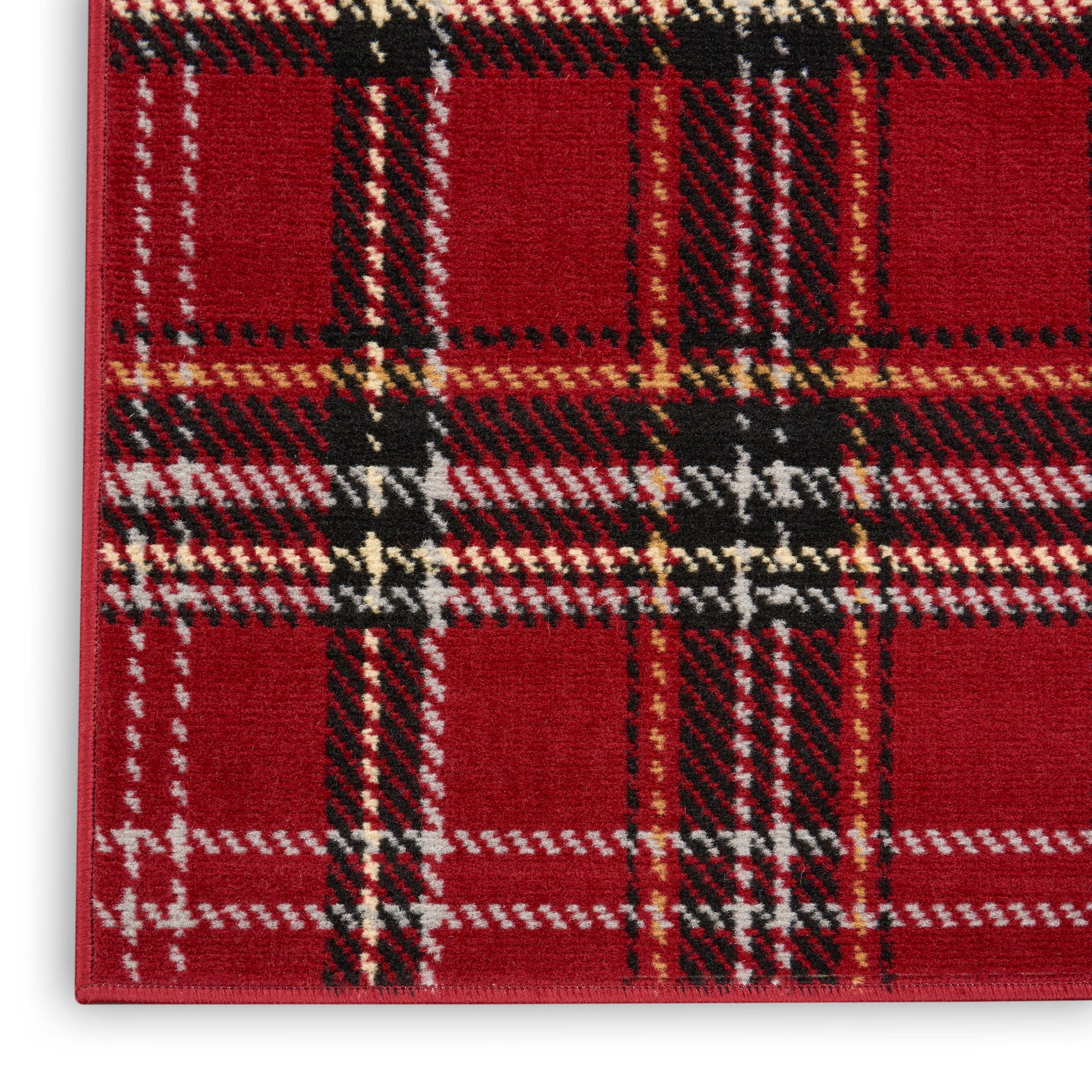 Red tartan plaid runner rug close-up; woven wool with black, white & yellow stripes in a classic plaid pattern.