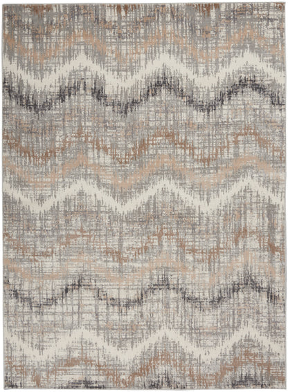 Neutral chevron rug in beige, taupe, gray and cream with distressed woven texture; living room accent.