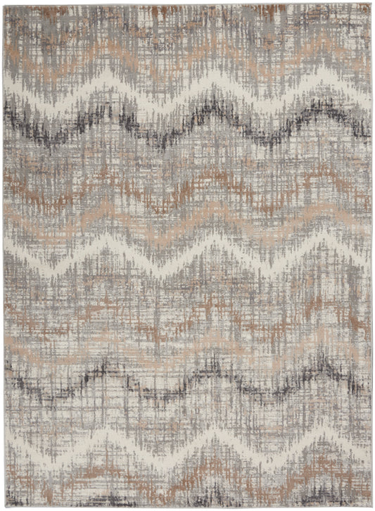 Neutral chevron rug in beige, taupe, gray and cream with distressed woven texture; living room accent.
