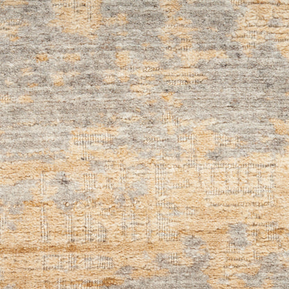 Muted gray and warm beige area rug with distressed geometric motifs and vintage texture.