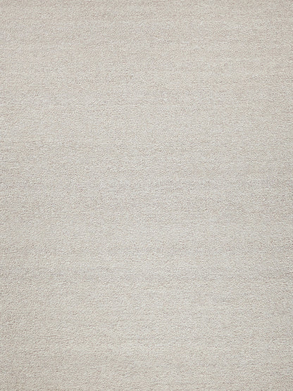 Beige textured rug with soft, looped pile in neutral tan.