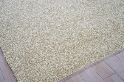 Beige shag rug with thick plush pile on light wood floor; cozy, modern living room or bedroom accent.