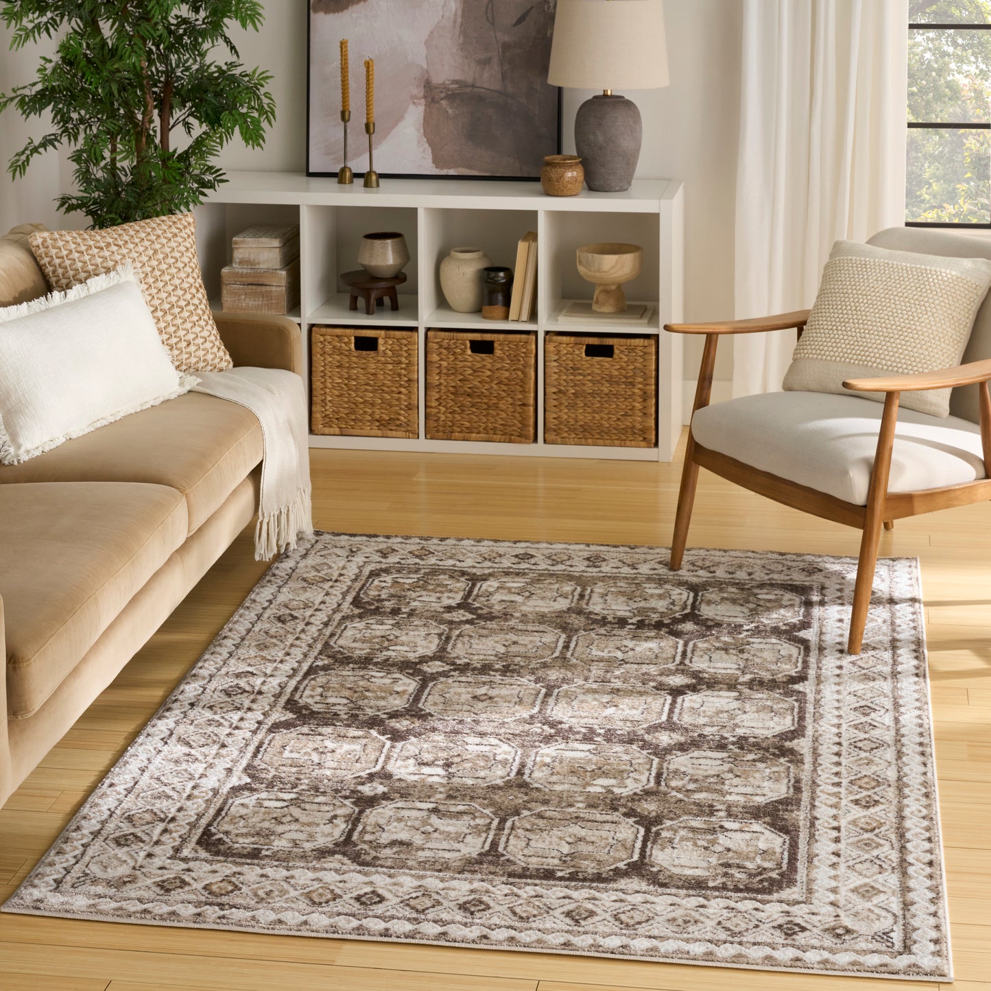 Neutral-toned oriental-style area rug with geometric medallions and border in taupe, beige, ivory in a cozy living room.