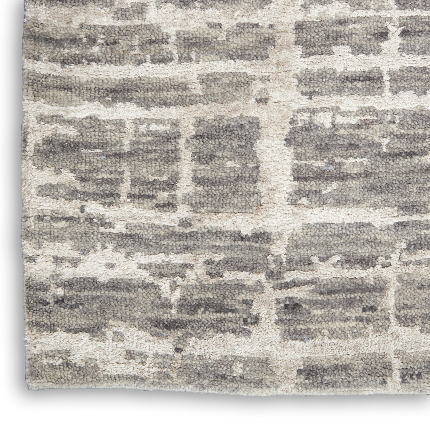 Soft shag rug with gray brick-pattern on creamy beige background; plush textured pile, modern geometric style.
