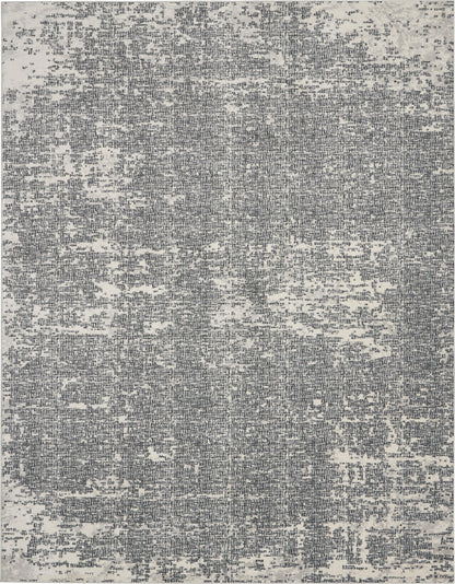 Gray-blue distressed abstract area rug with a vintage, worn pattern.