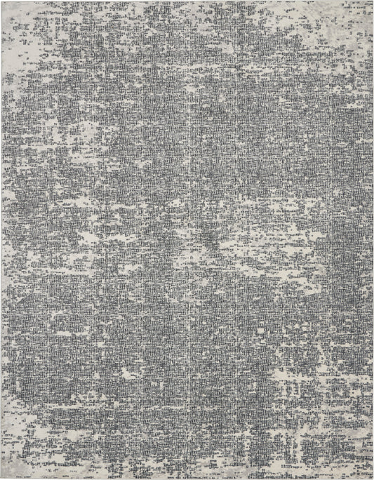 Gray-blue distressed abstract area rug with a vintage, worn pattern.