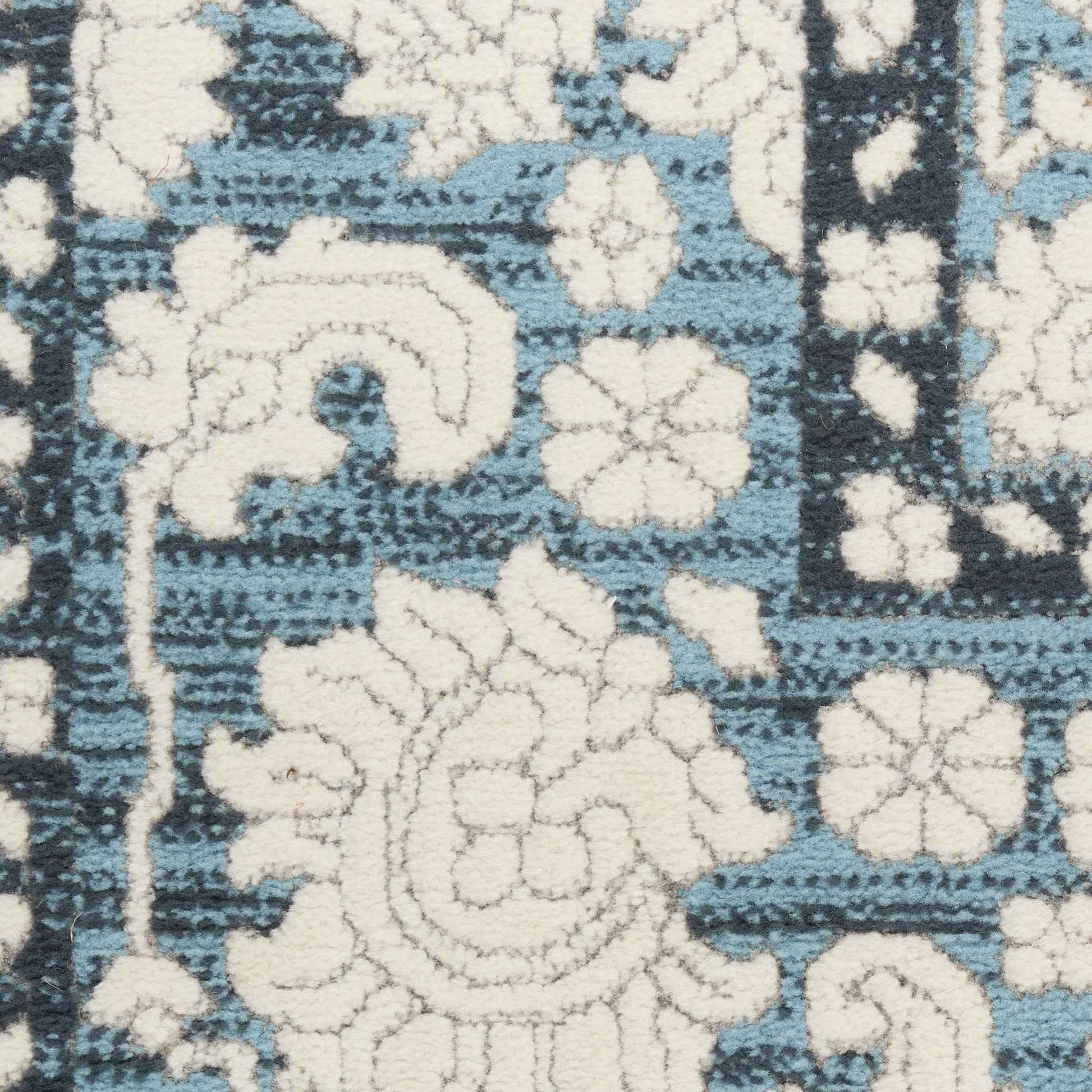 Blue and cream woven rug with ornate floral motif and decorative border, 8' x 10'.