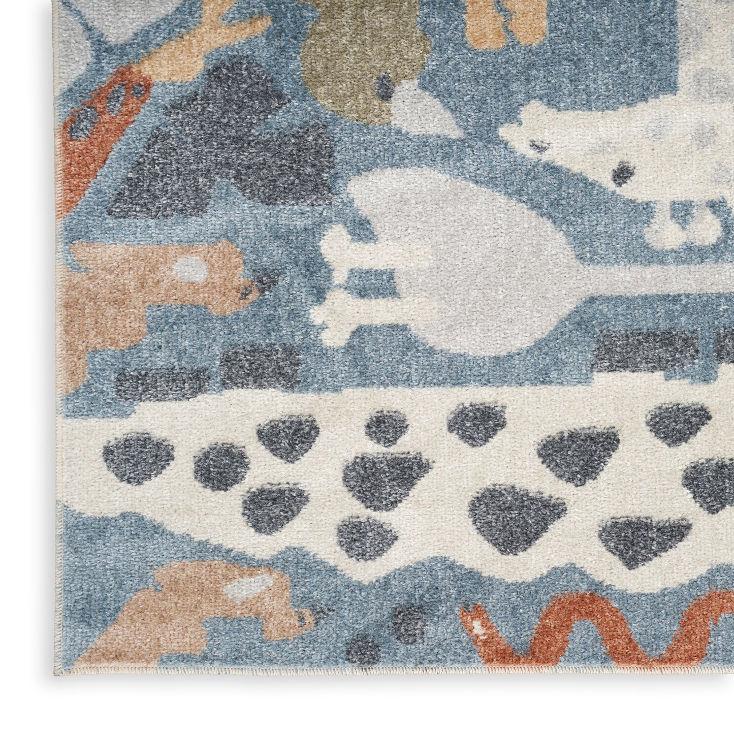 Abstract woven rug in blue, ivory, beige and orange with animal silhouettes and geometric patterns.