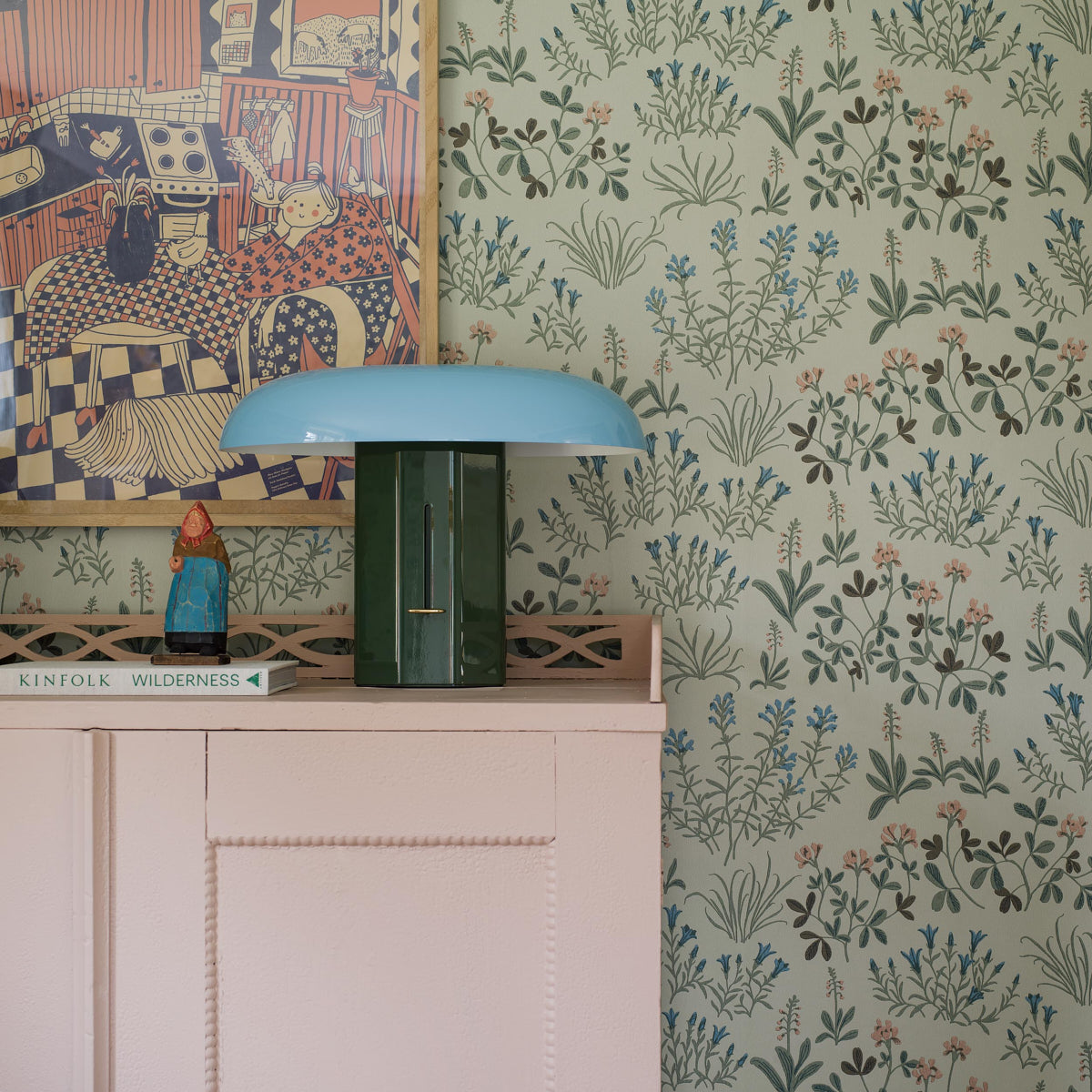Floral wallpaper with a vintage-style mineral-inspired blue pattern on the wall beside a white cabinet.
