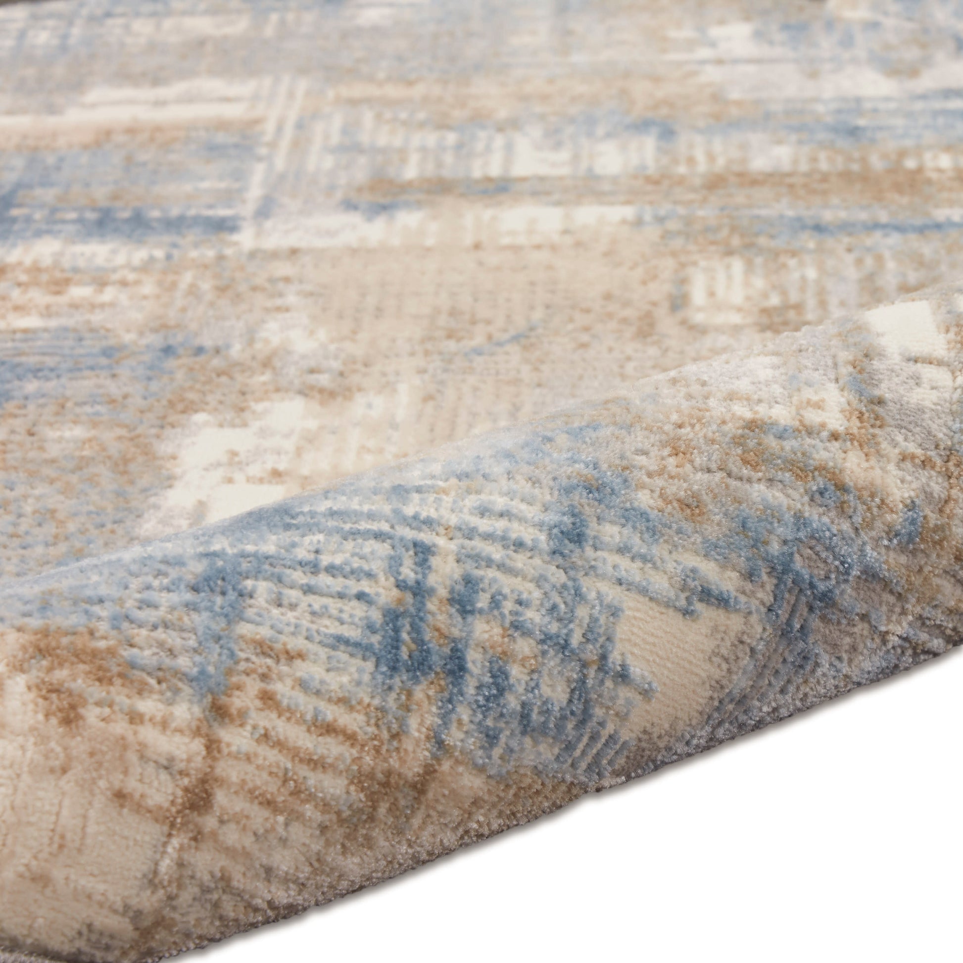 Beige and blue abstract patterned runner rug with muted geometric shapes, rolled edge, soft pile.