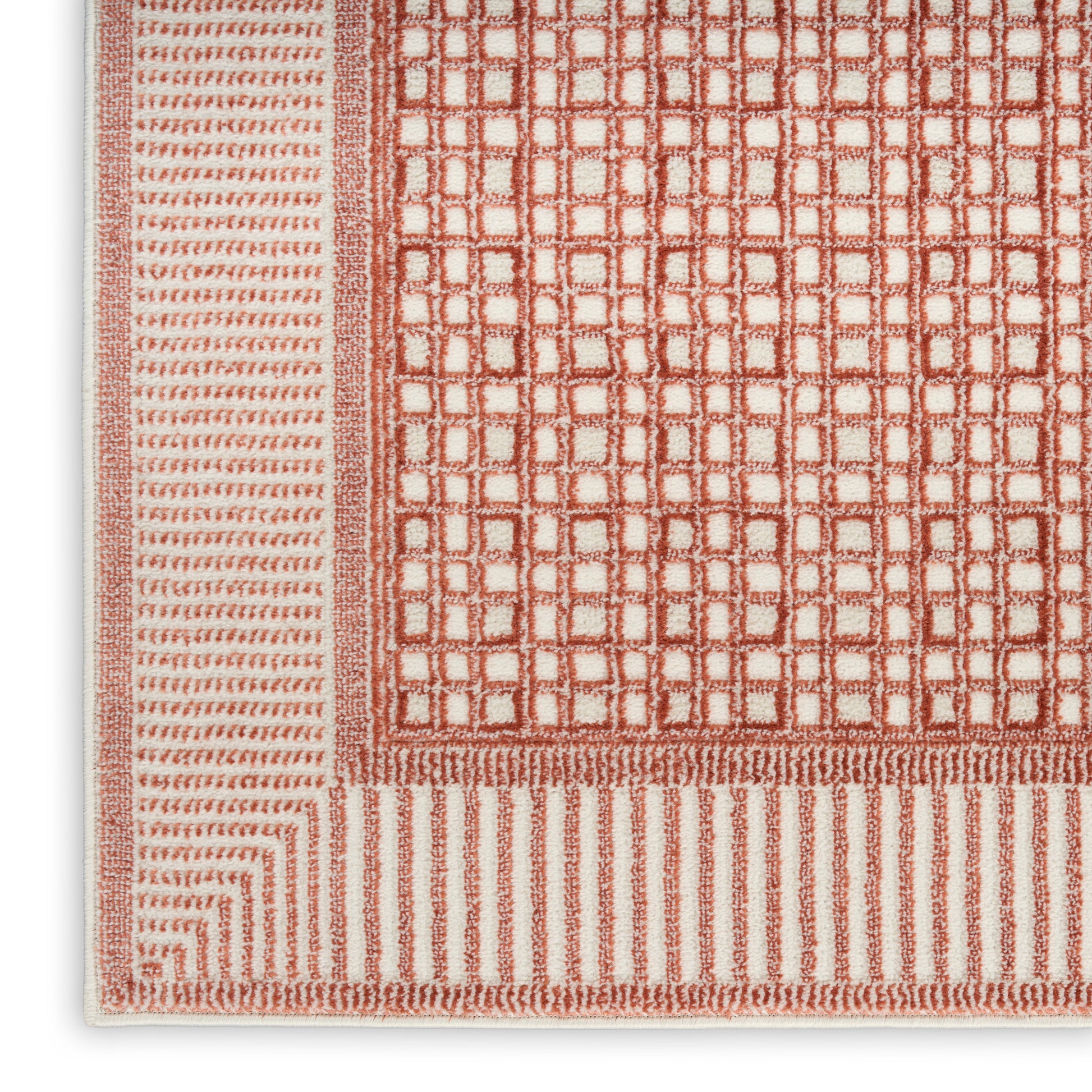 Terracotta and cream woven rug with square-grid center and striped outer borders.