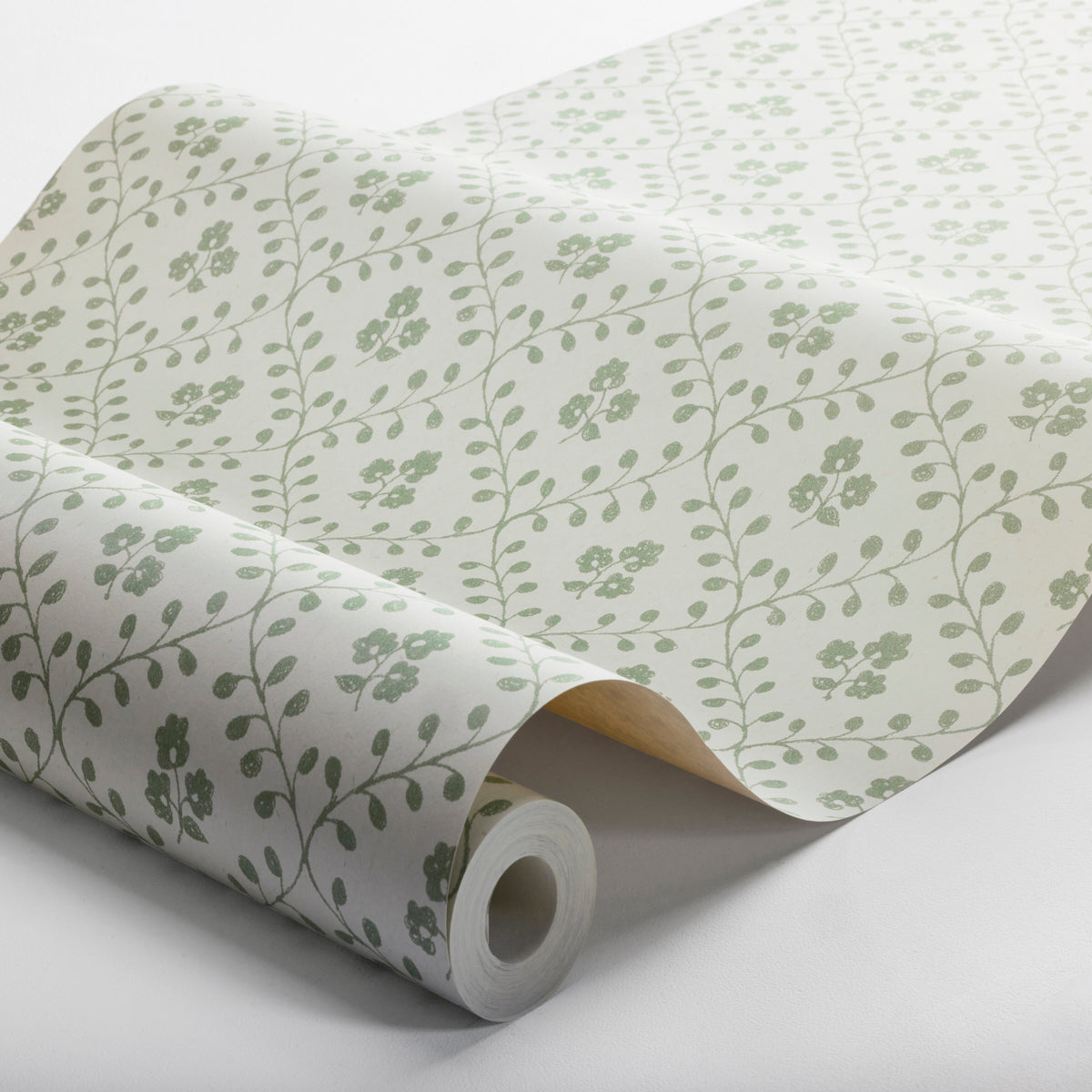 Rolled wallpaper in white with pale green botanical vine pattern and small flowers.