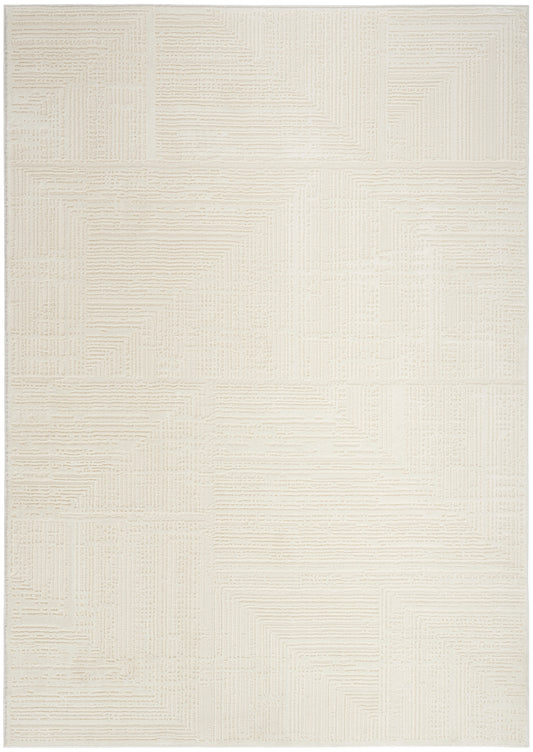 Cream textured rug with subtle geometric patchwork created by raised linear patterns.