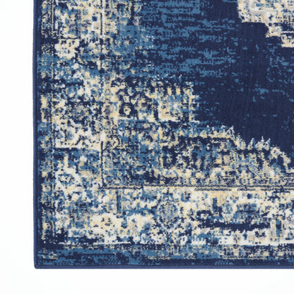 Blue abstract patterned rug with navy, light blue and ivory tones; rectangular with a dark blue border.