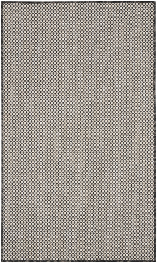 Beige flat-weave rug with tiny black diamond lattice pattern and dark border, rectangular.