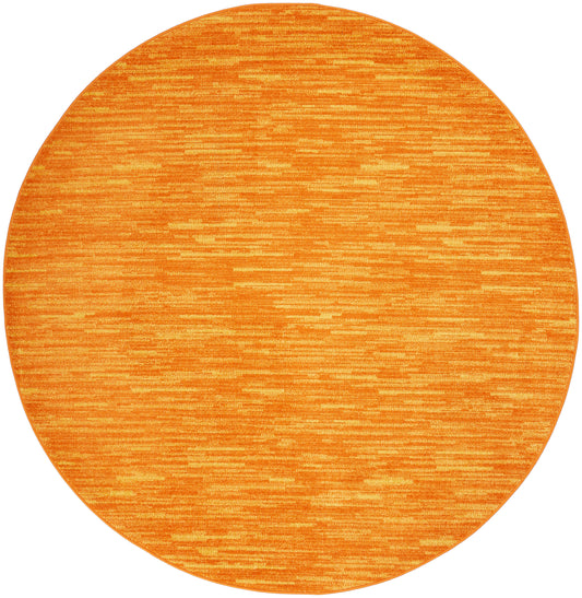 Round orange rug with subtle horizontal stripes; brushed texture in bright tangerine for modern living spaces.