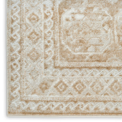 Beige and cream oriental rug close-up with plush pile, geometric border and medallion motif.
