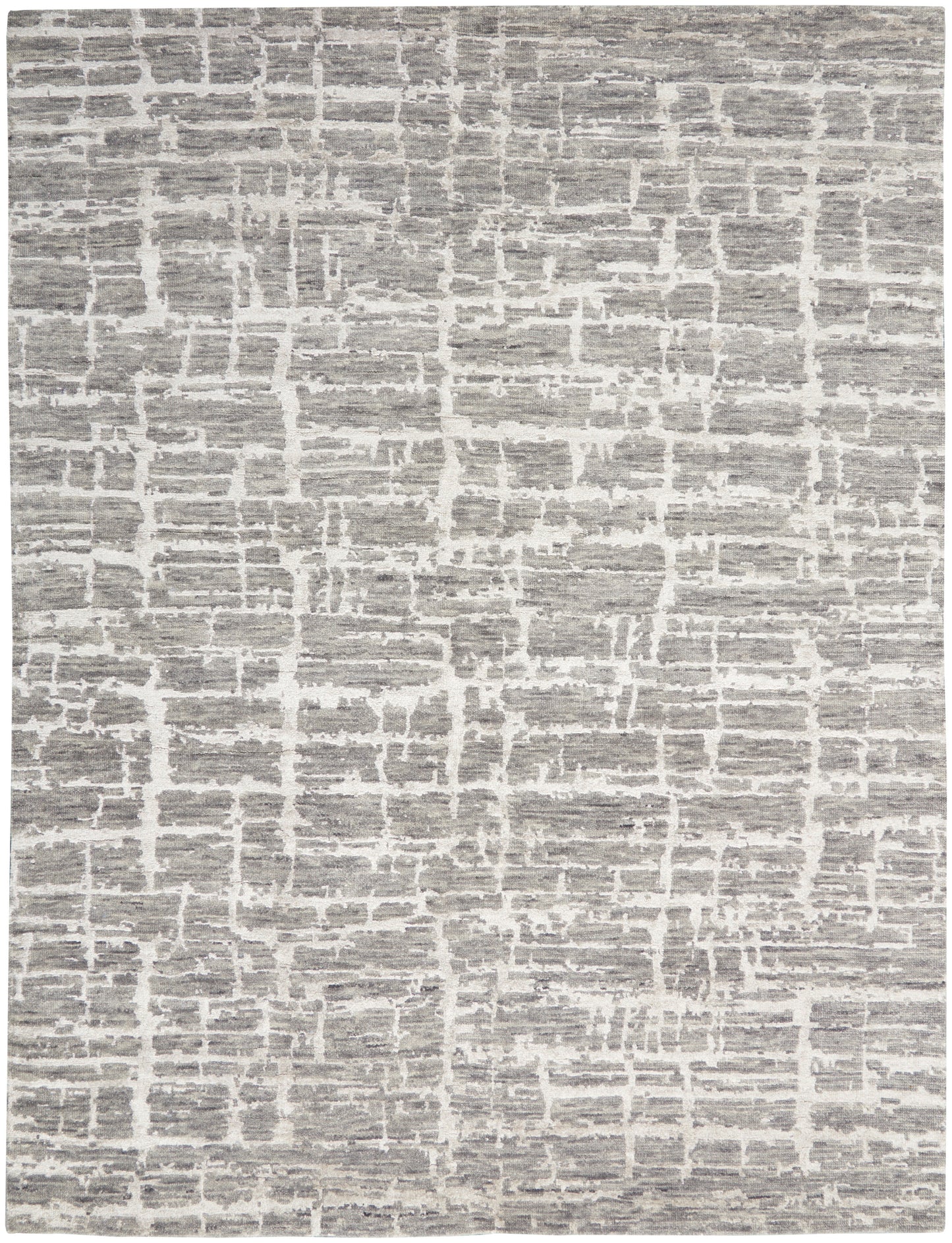 Gray and white rug with irregular block pattern, textured flat-weave for modern neutral decor.