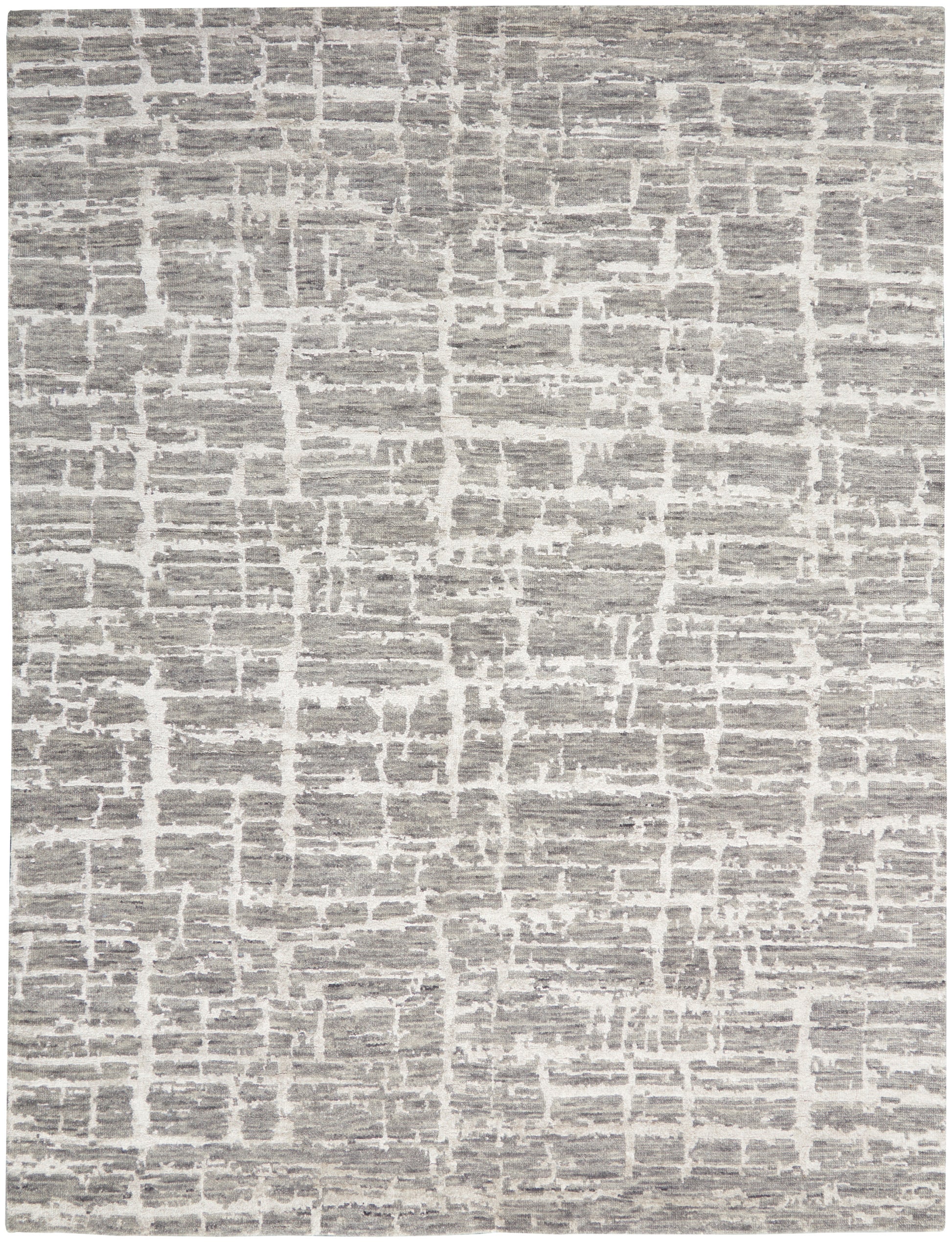 Gray and white rug with irregular block pattern, textured flat-weave for modern neutral decor.