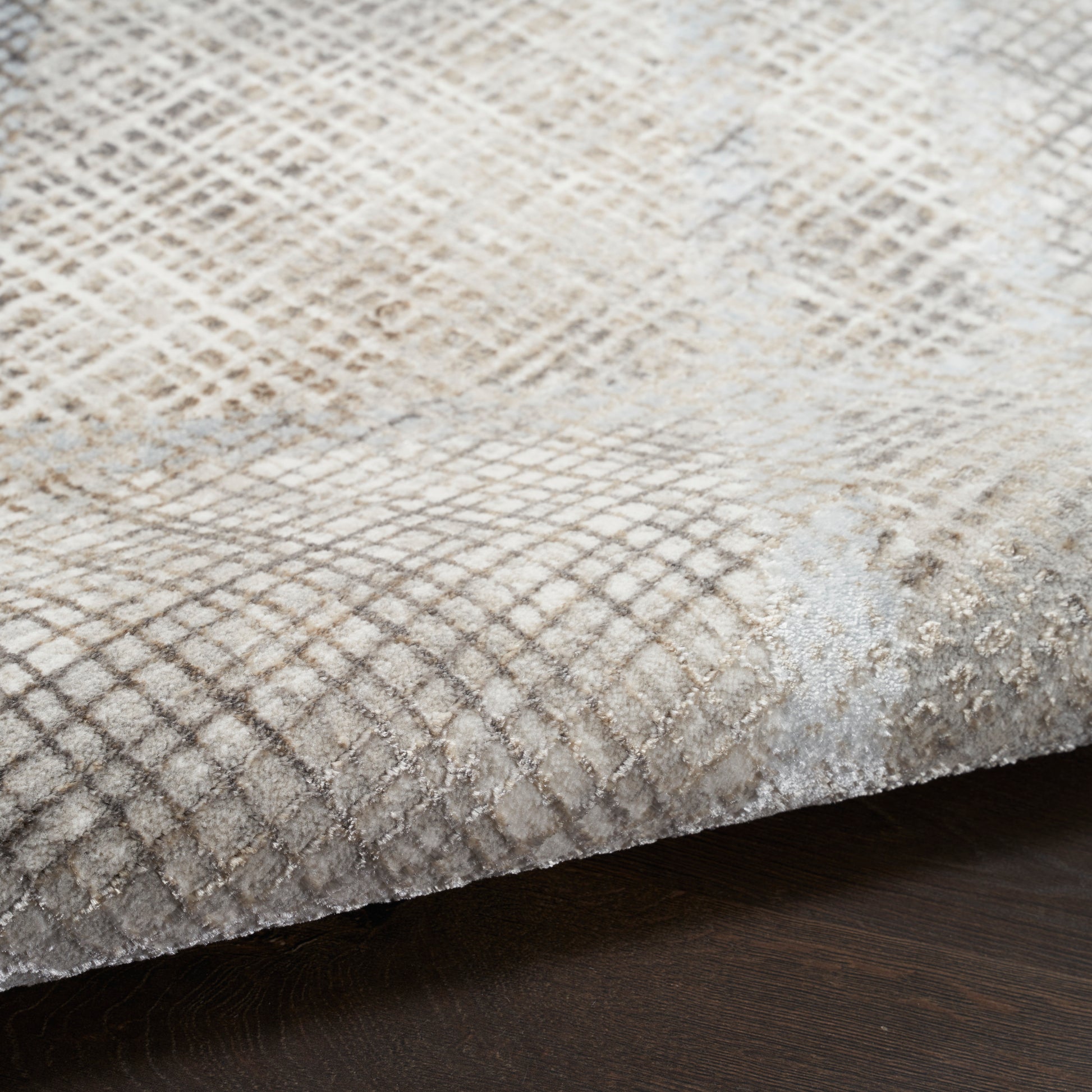 Beige plush runner rug with a subtle diamond grid pattern and soft pile on a dark wood floor.