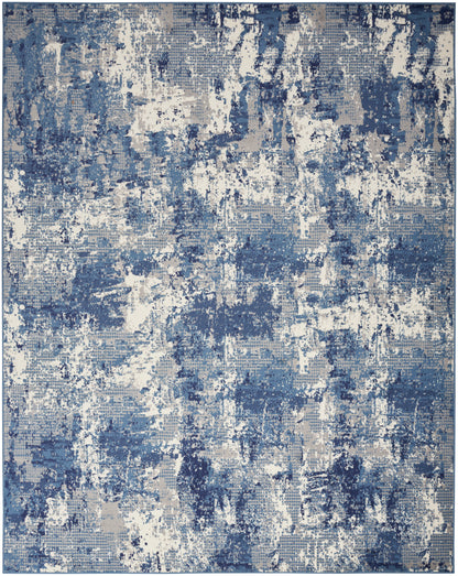 Rectangular blue and white abstract rug with distressed, patchy pattern for modern living spaces.