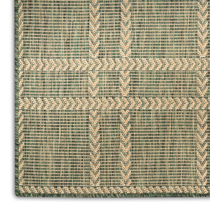 Rectangular flatweave rug in sage green with natural beige geometric chevrons and woven texture.