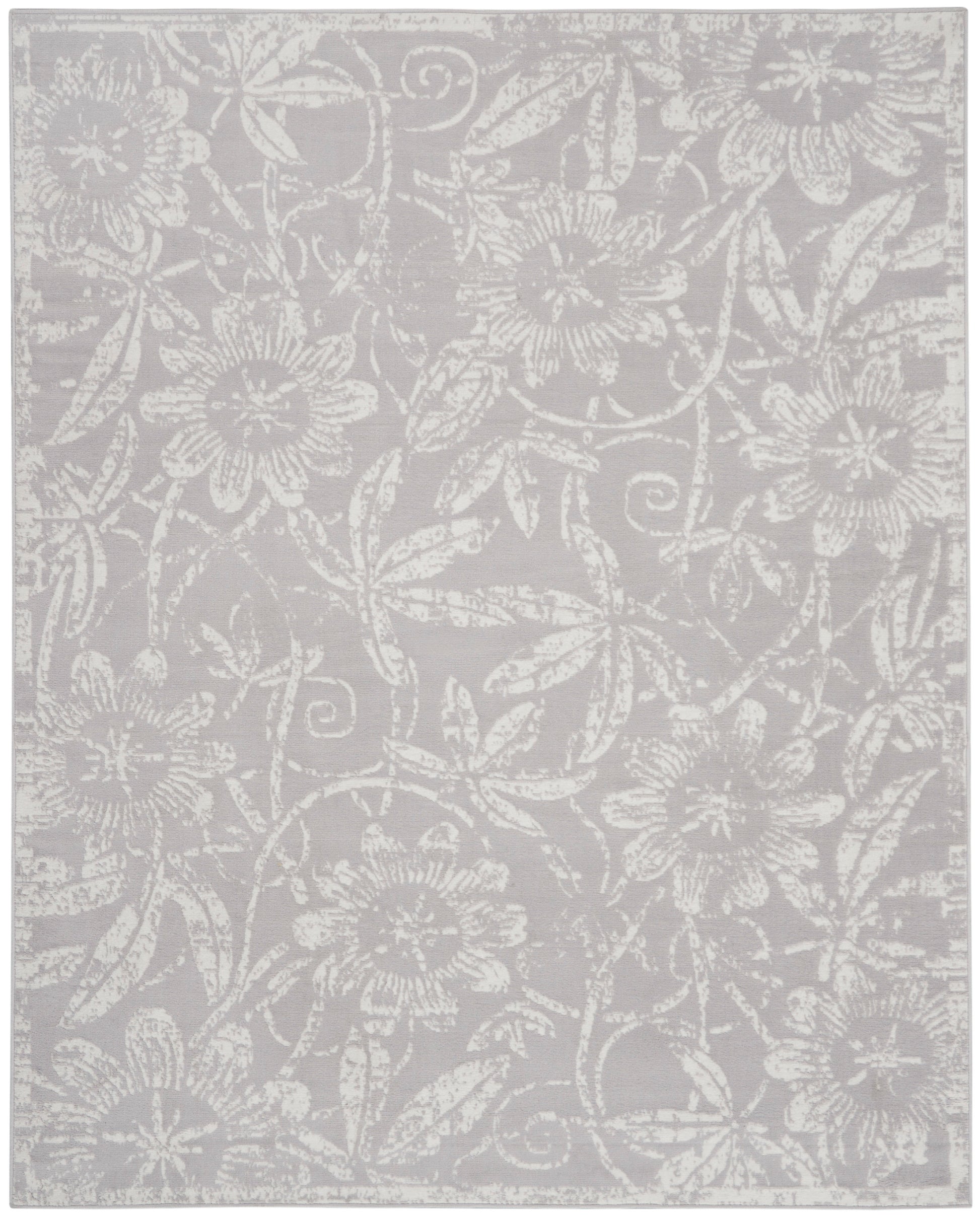 Light gray area rug featuring an allover white floral damask pattern and woven texture.