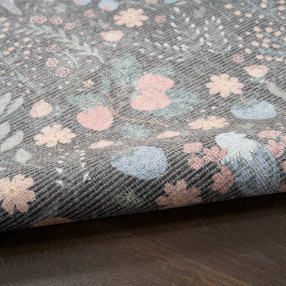 Denim-like fabric with pastel floral print in pink, blue and peach on gray twill, folded edge.