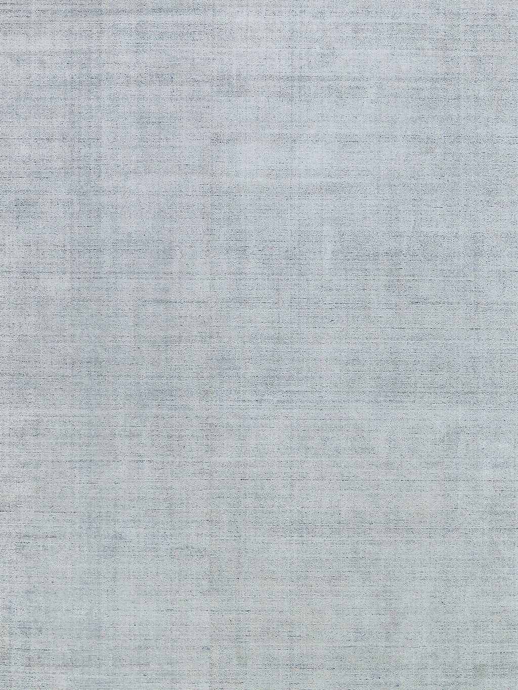 Light blue-gray linen-textured woven rug with subtle tonal variations.