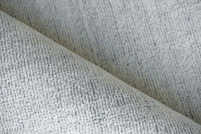 Light gray boucle rug, close-up of a textured woven surface, size 2' x 3'.