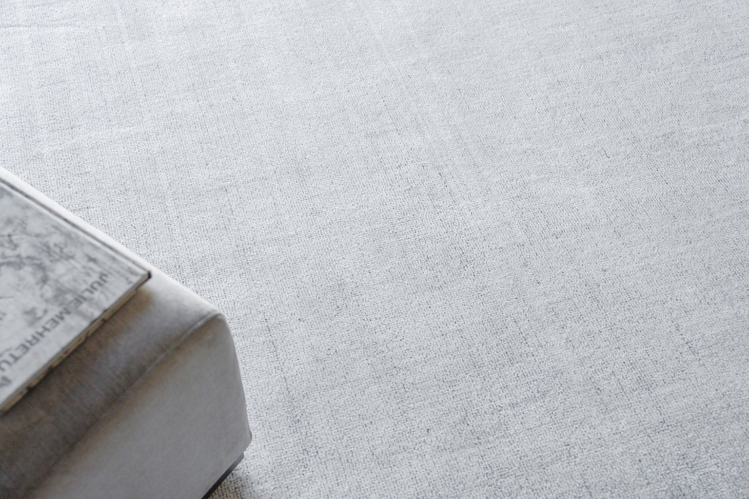 Gray rug with a subtle marble-pattern design on a pale woven background; 8' x 10'.