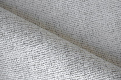 Close-up of a light gray boucle rug with a soft looped weave; indoor hand-loomed, 2' x 3'.