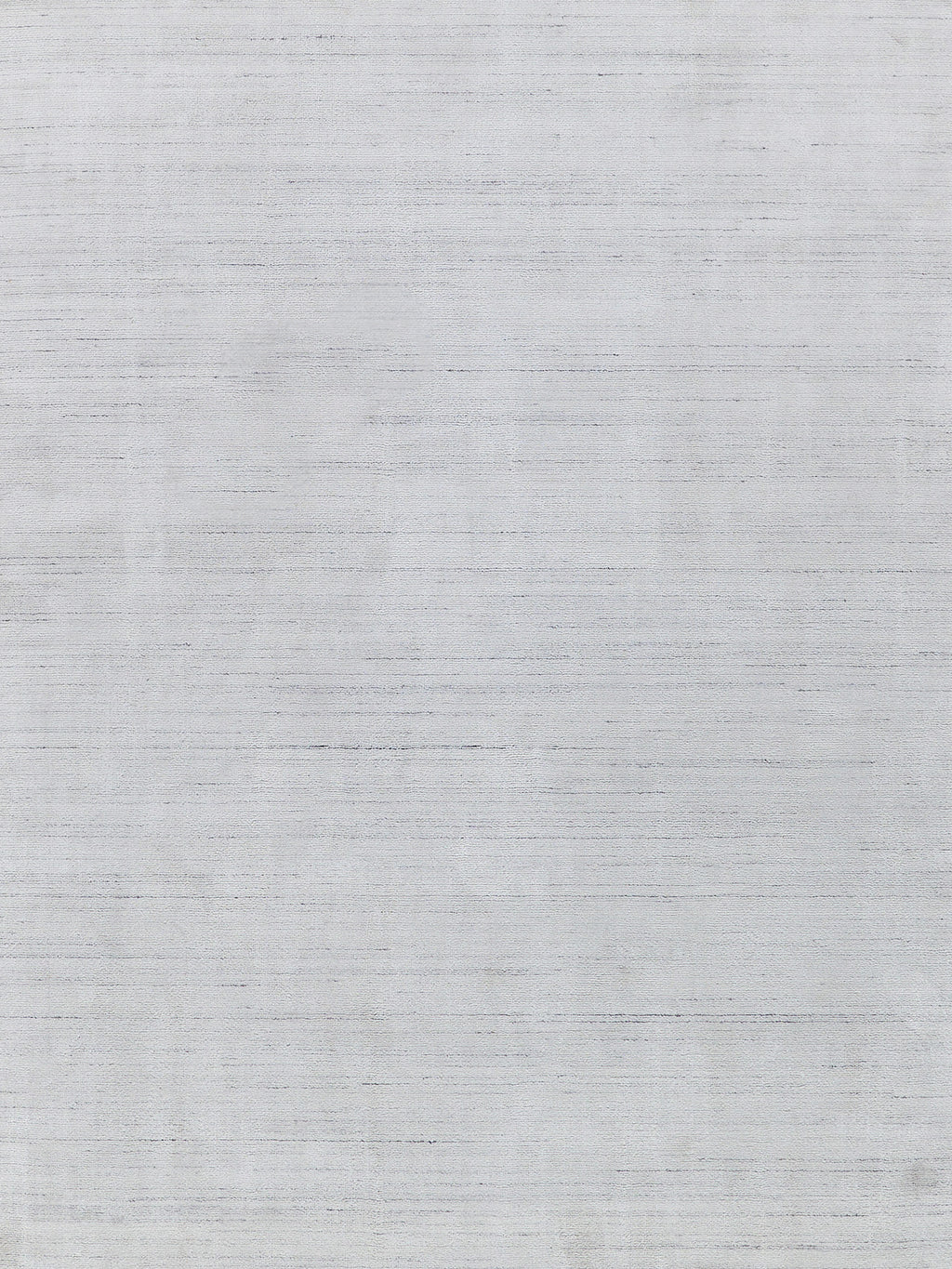 Light gray hand-loomed rug with subtle woven texture, 2' x 3'.