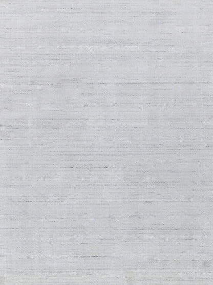Light gray rug with a subtle textured weave and horizontal striations; indoor setting.